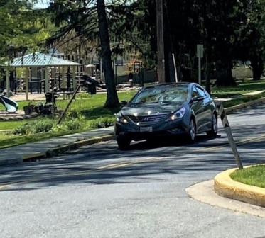 A closer shot of a car on Thomas Street by Plumtree Park in Bel Air.
